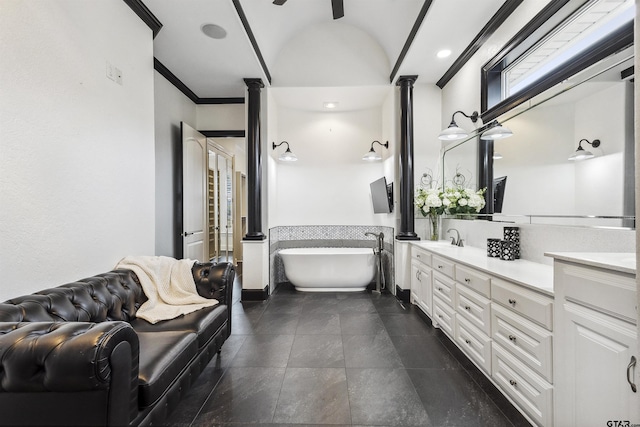 bathroom with vanity, ornamental molding, a tub, and ceiling fan