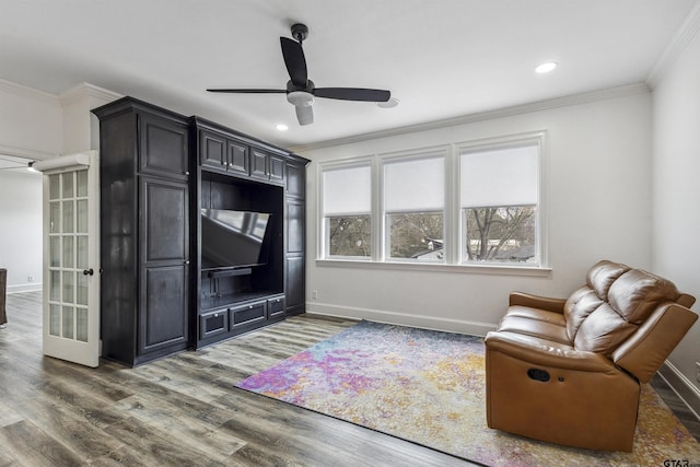 living room with ceiling fan, ornamental molding, and dark hardwood / wood-style floors