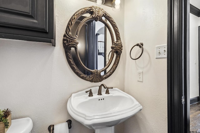 bathroom featuring toilet and sink