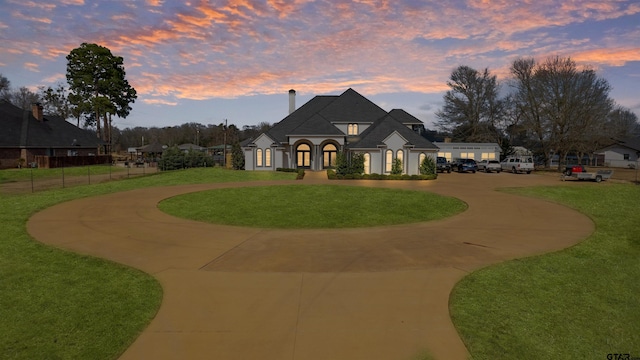 french country style house featuring a yard