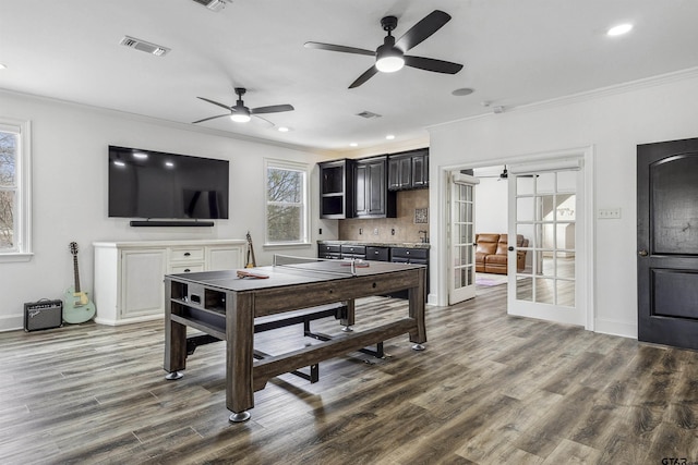 dining area featuring ornamental molding, dark hardwood / wood-style flooring, and french doors