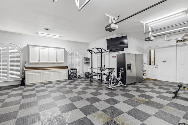 interior space with stainless steel refrigerator with ice dispenser and a garage door opener