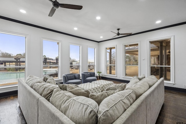 living room featuring crown molding, a healthy amount of sunlight, and dark hardwood / wood-style flooring