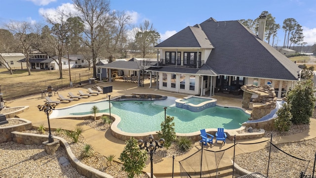 view of pool with an in ground hot tub and a patio