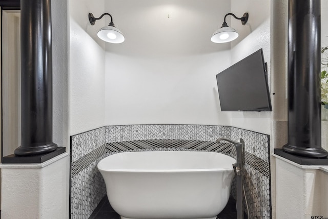 bathroom with tile walls and a tub to relax in