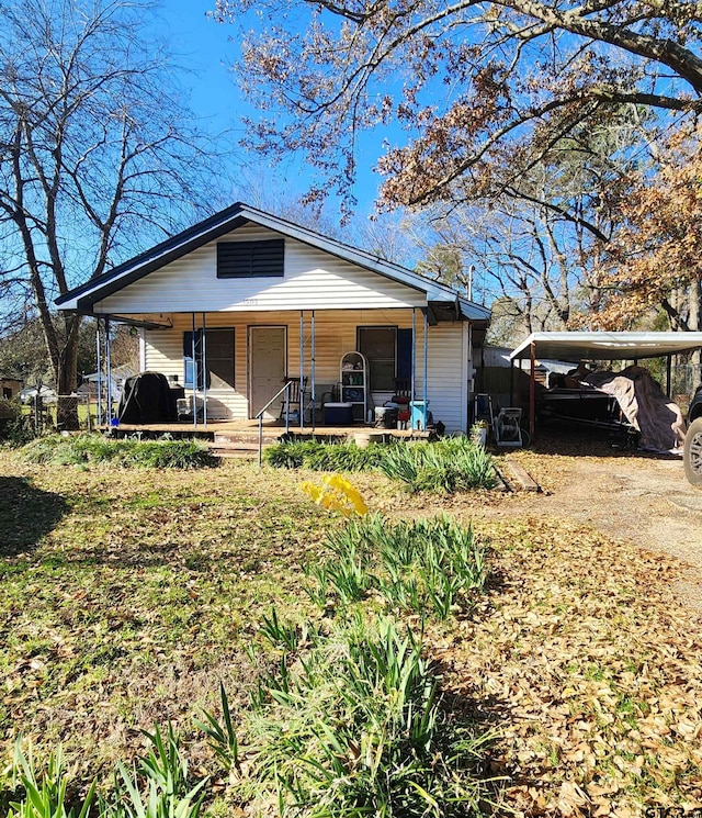 view of front of property with a carport and covered porch