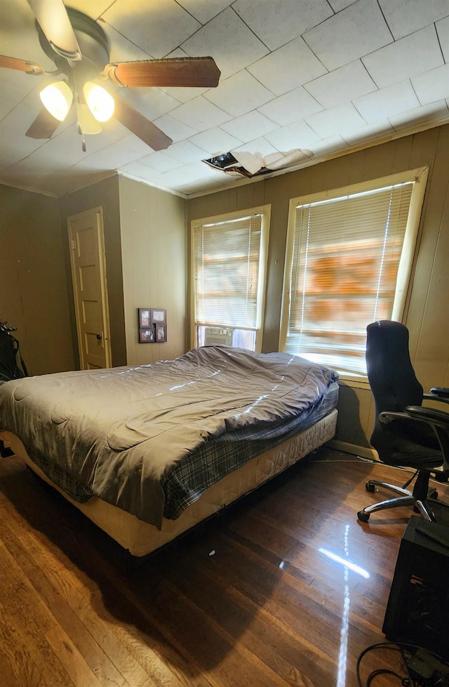 bedroom featuring dark hardwood / wood-style flooring and ceiling fan