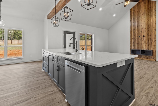 kitchen featuring a center island with sink, sink, stainless steel dishwasher, decorative light fixtures, and light hardwood / wood-style floors