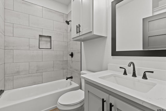 full bathroom with vanity, tiled shower / bath combo, and toilet