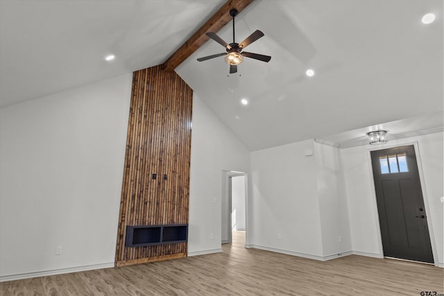 unfurnished living room featuring ceiling fan, beamed ceiling, light hardwood / wood-style floors, and high vaulted ceiling