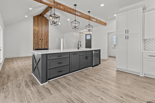 kitchen with beam ceiling, light hardwood / wood-style flooring, white cabinets, and decorative light fixtures