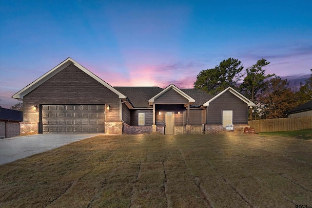 view of front of property with a lawn and a garage