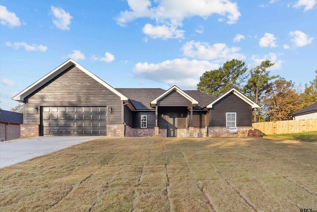 view of front of house featuring a garage and a front yard