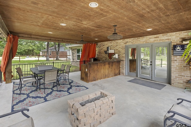 view of patio / terrace with an outdoor fire pit, outdoor dining area, and fence