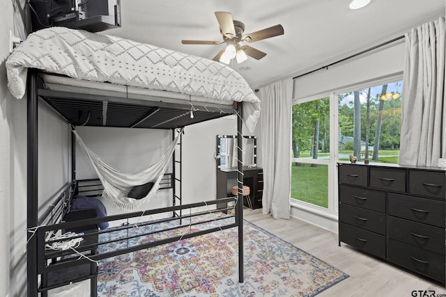 bedroom featuring light wood-style flooring, a ceiling fan, and recessed lighting