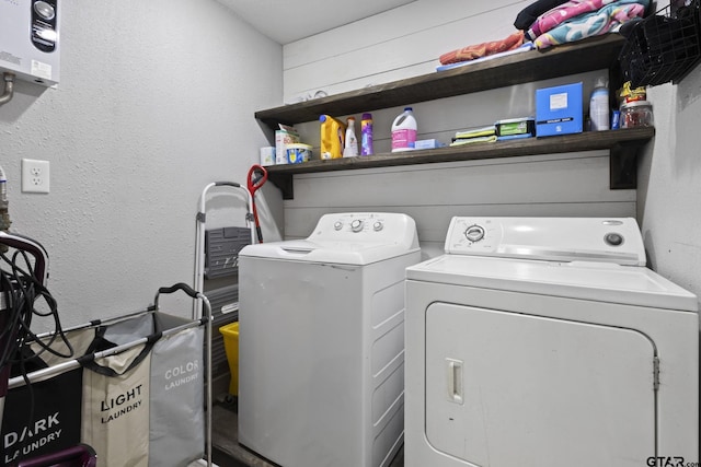 laundry area with washing machine and clothes dryer and laundry area