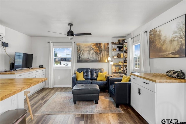 living room with dark hardwood / wood-style flooring and ceiling fan