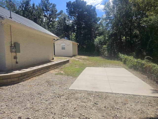 view of yard featuring a patio area and a shed