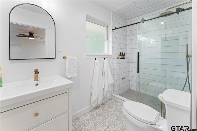 bathroom with walk in shower, vanity, ceiling fan, toilet, and tile patterned floors