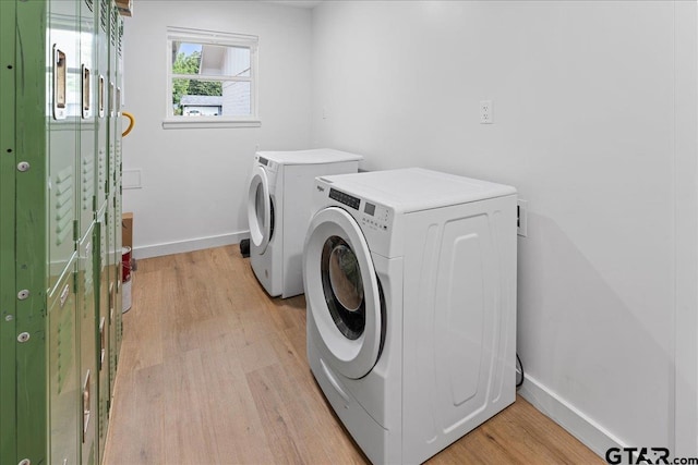 washroom featuring independent washer and dryer and light hardwood / wood-style flooring