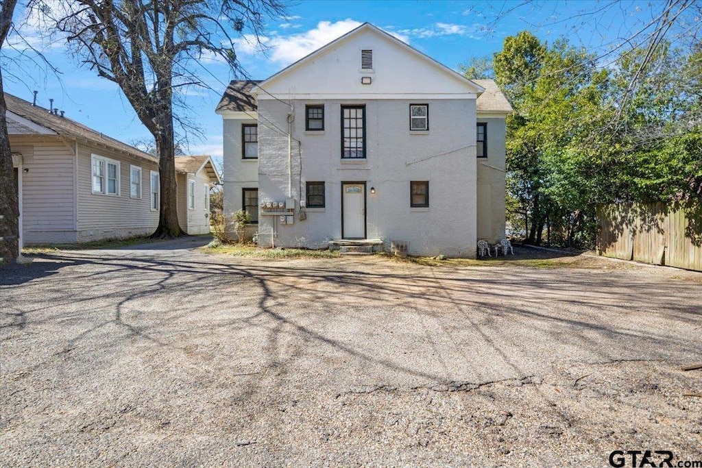 rear view of property with fence