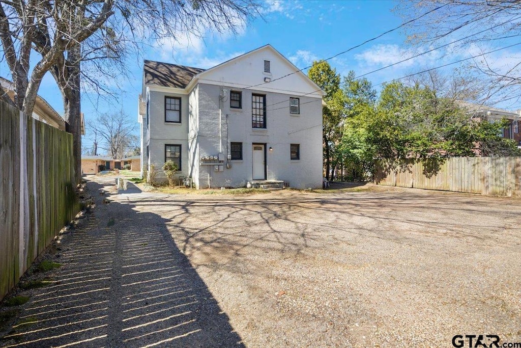 back of property with fence