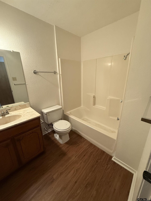 full bathroom with hardwood / wood-style flooring, toilet, vanity, and  shower combination