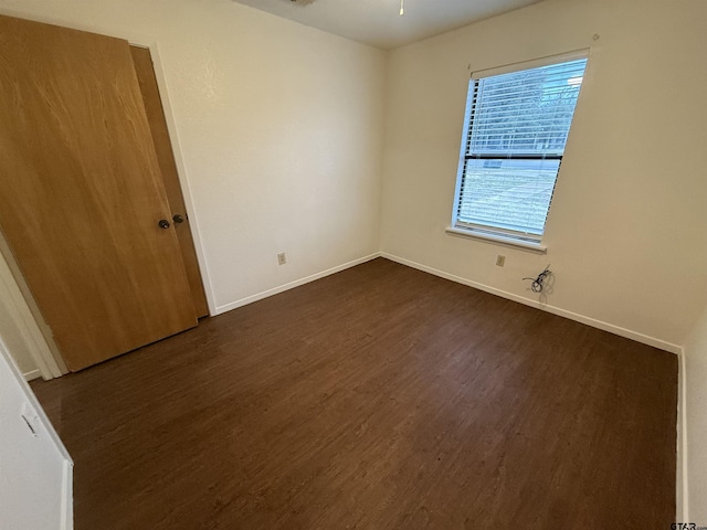 empty room featuring dark hardwood / wood-style flooring