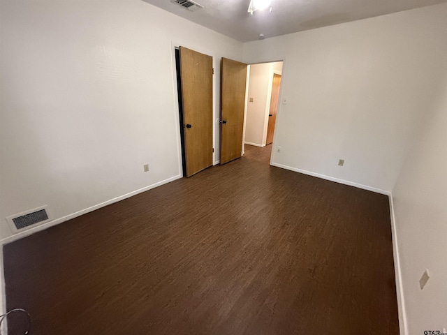 spare room featuring dark hardwood / wood-style floors