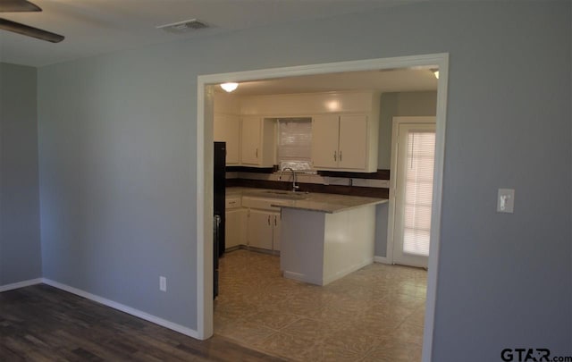 kitchen with white cabinets, ceiling fan, dark hardwood / wood-style flooring, and sink