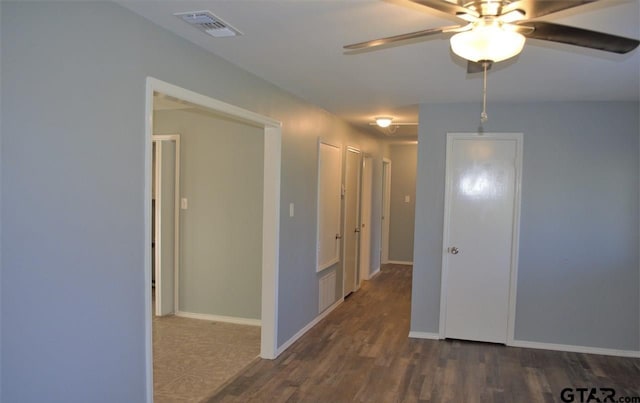 empty room with dark hardwood / wood-style flooring and ceiling fan