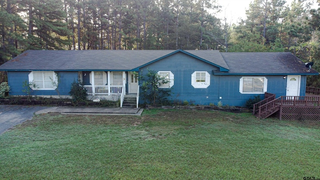 ranch-style house with covered porch and a front yard