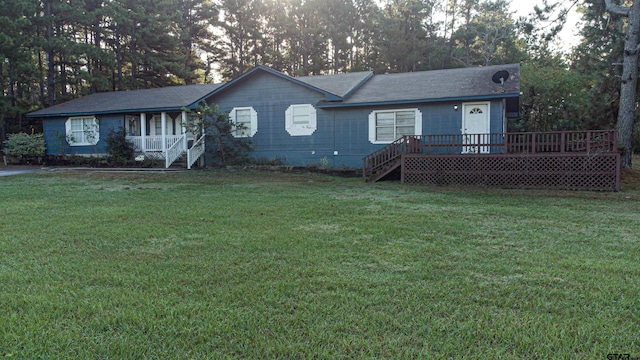 ranch-style home with a front lawn and a deck