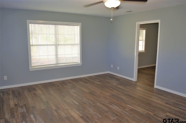 unfurnished room with dark hardwood / wood-style floors, plenty of natural light, and ceiling fan