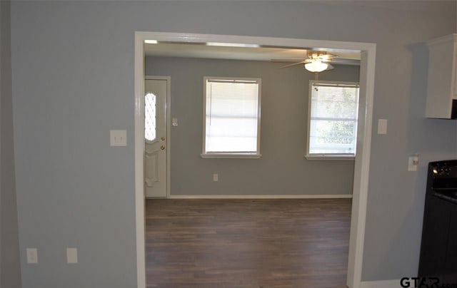 interior space featuring ceiling fan and dark wood-type flooring