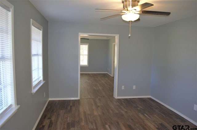 spare room with ceiling fan and dark hardwood / wood-style flooring