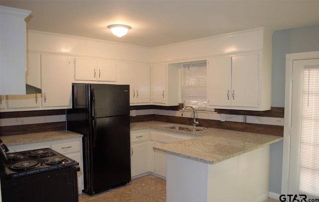 kitchen with kitchen peninsula, sink, white cabinets, and black appliances