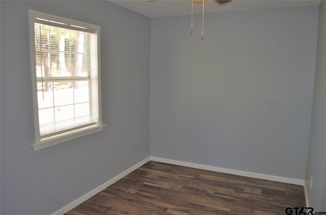 empty room with ceiling fan and dark wood-type flooring