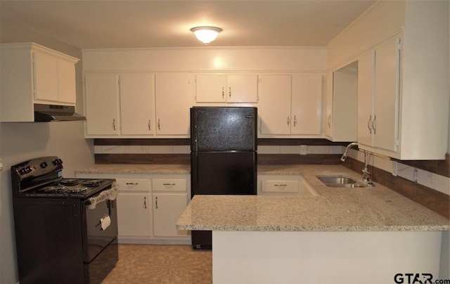 kitchen featuring light stone countertops, white cabinetry, sink, kitchen peninsula, and black appliances