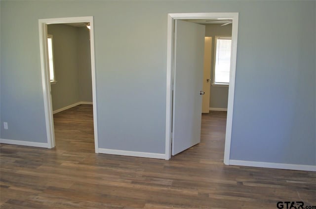 unfurnished room featuring dark wood-type flooring