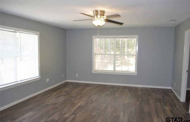 spare room with ceiling fan and dark hardwood / wood-style flooring