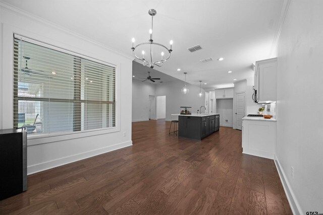 4132 Palo Pinto Creek Cir, Tyler, TX 75703 - unfurnished living room featuring a chandelier, crown molding, dark wood finished floors, a sink, and recessed lighting