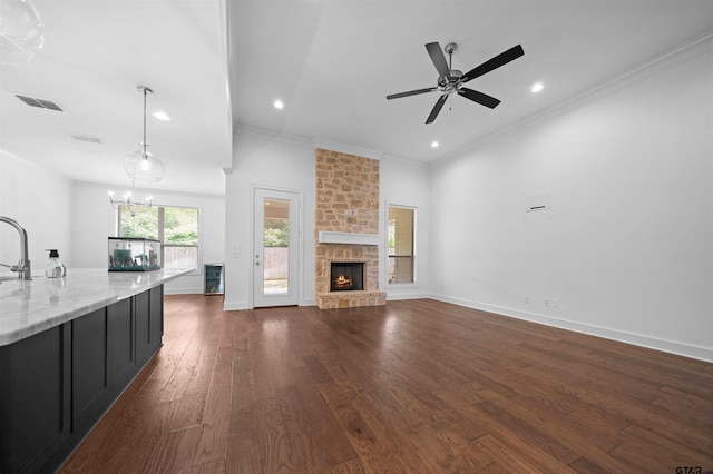 4132 Palo Pinto Creek Cir, Tyler, TX 75703 - unfurnished living room with ornamental molding, dark wood-style flooring, recessed lighting, a ceiling fan, and a fireplace