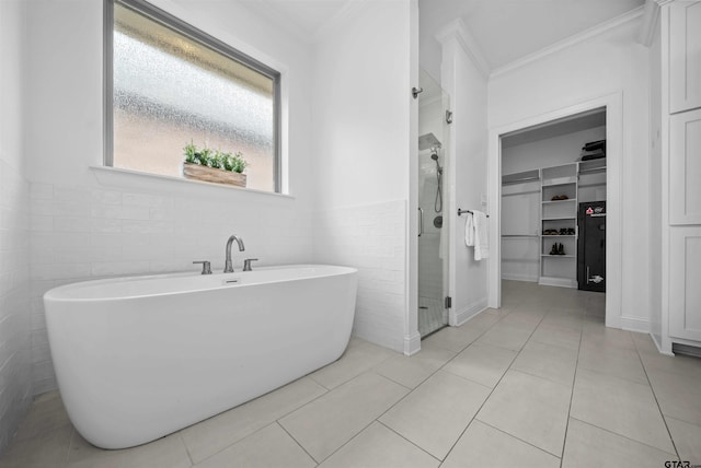 4132 Palo Pinto Creek Cir, Tyler, TX 75703 - bathroom featuring crown molding, a walk in closet, tile walls, a shower stall, and a freestanding tub