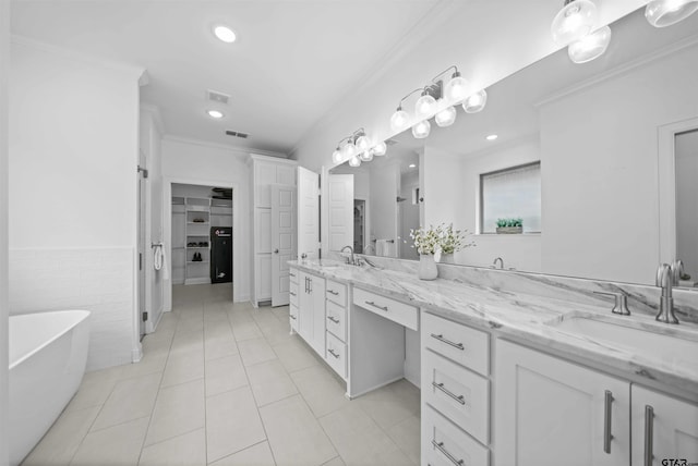 4132 Palo Pinto Creek Cir, Tyler, TX 75703 - full bathroom featuring double vanity, a soaking tub, tile patterned flooring, crown molding, and a spacious closet