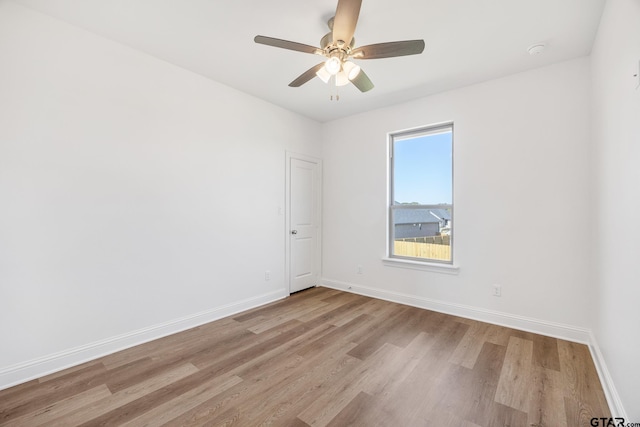 empty room featuring ceiling fan and light hardwood / wood-style flooring