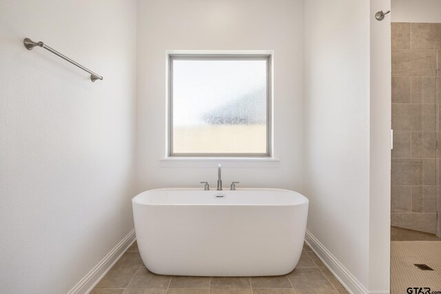 482 Mary Cir, Bullard, TX 75757 - full bath featuring tile patterned flooring, a freestanding bath, baseboards, and tiled shower