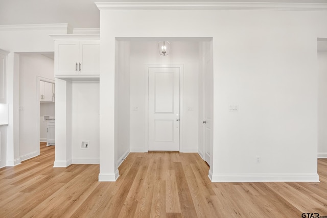 interior space with light hardwood / wood-style flooring and ornamental molding