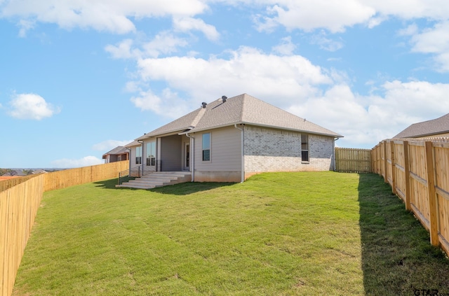 back of property featuring a lawn