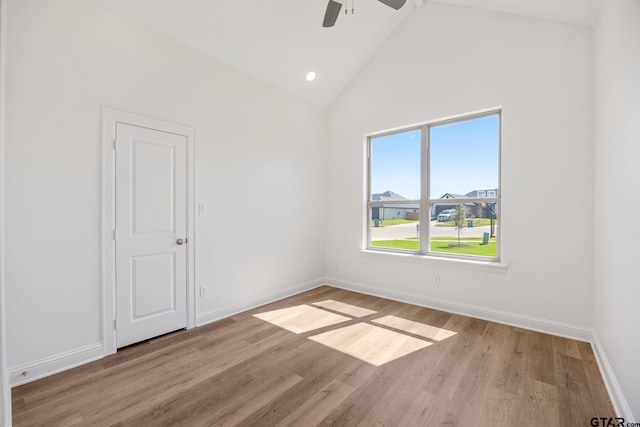 unfurnished room featuring ceiling fan, high vaulted ceiling, and light hardwood / wood-style floors